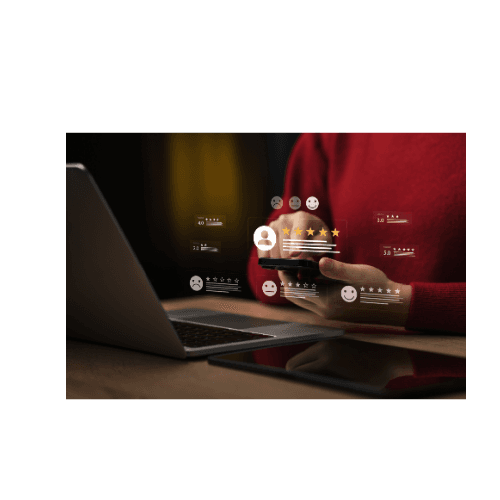 Customer checking review feedback on a phone beside a laptop